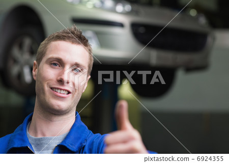 Car mechanic gesturing thumbs up 6924355