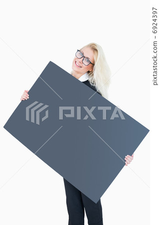 Portrait of happy business woman holding blank board 6924397