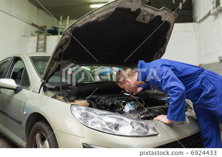 Mechanic working under car bonnet Mechanic working under car bonnet 6924433