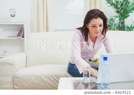 Young woman using laptop at home 6924521