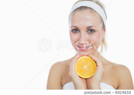 Happy woman holding slice of orange 6924838