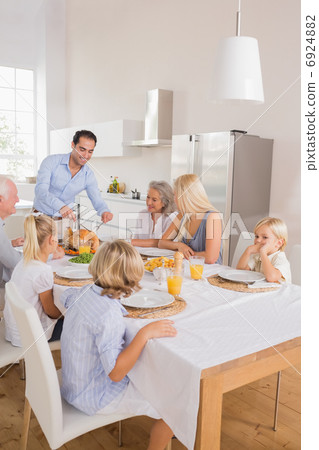 Happy father cutting the turkey Happy father cutting the turkey 6924882