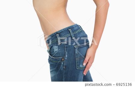 Side midsection of slim woman in jeans Side midsection of slim woman in jeans 6925136