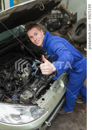 Auto mechanic showing thumbs up sign 6925199