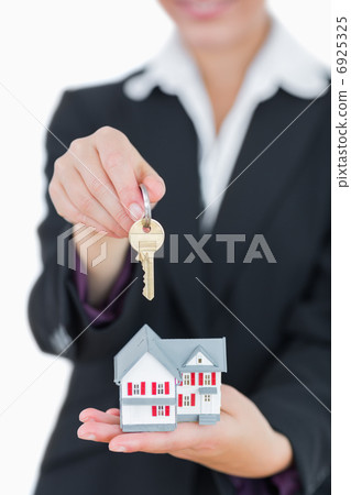 Real estate agent with house model and keys Real estate agent with house model and keys 6925325