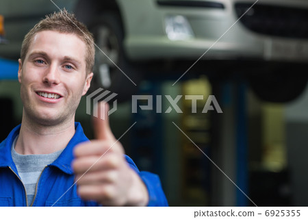 Smart car mechanic gesturing thumbs up Smart car mechanic gesturing thumbs up 6925355
