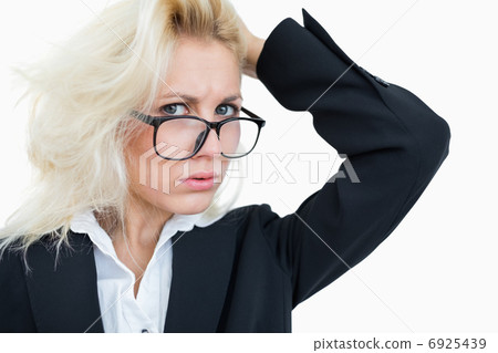 Close-up portrait of frustrated business woman scratching head Close-up portrait of frustrated business woman scratching head 6925439