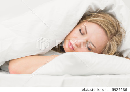 Beautiful young woman sleeping in bed Beautiful young woman sleeping in bed 6925586