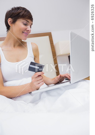 Smiling brunette shopping online Smiling brunette shopping online 6926326