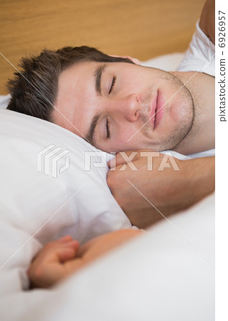 Man asleep in bed Man asleep in bed 6926957