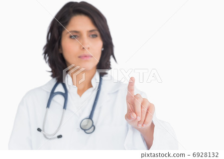 Pretty doctor pointing the finger in the air Pretty doctor pointing the finger in the air 6928132