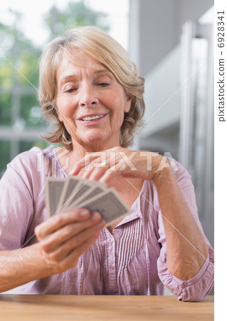 Happy woman playing cards Happy woman playing cards 6928341