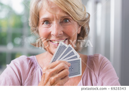 Close up of a happy woman playing cards 6928343