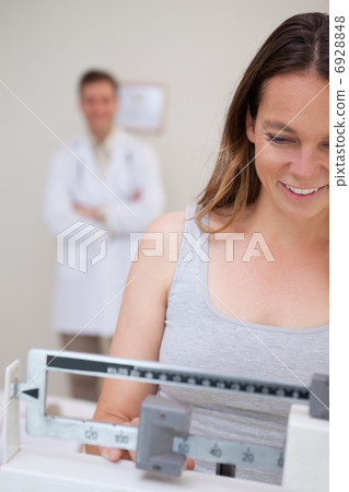Weight measuring woman 6928848