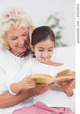 Granddaughter and grandmother reading a novel together Granddaughter and grandmother reading a novel together 6928902