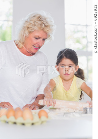 Granddaughter and grandmother baking together Granddaughter and grandmother baking together 6928912