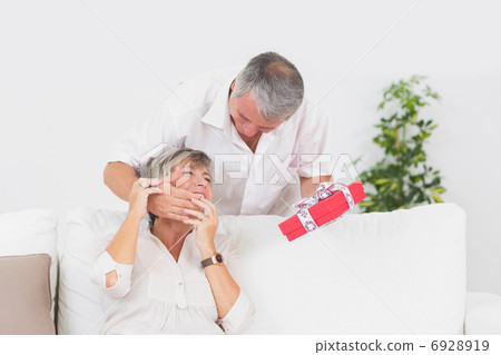 Old man hiding eyes his wife to give a gift Old man hiding eyes his wife to give a gift 6928919
