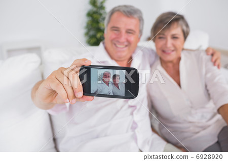 Old man taking a photo of him and his wife Old man taking a photo of him and his wife 6928920