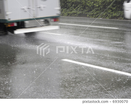 Splash of a car in rainy weather 6930070