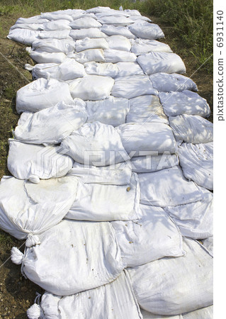 Sandbag piled on levee 6931140