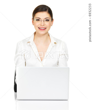 woman sits from the  table with laptop in white shirt 6932233