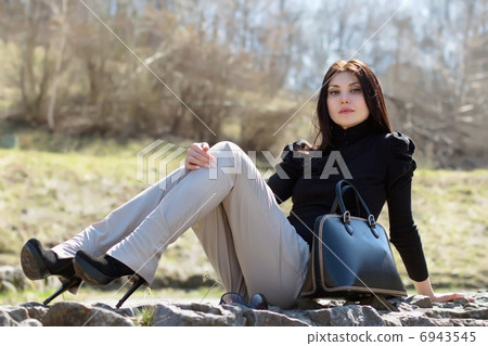 Brunette sitting on the rock Brunette sitting on the rock 6943545
