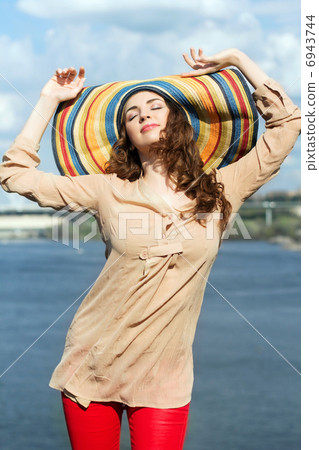 Brunette wearing colorful hat Brunette wearing colorful hat 6943744