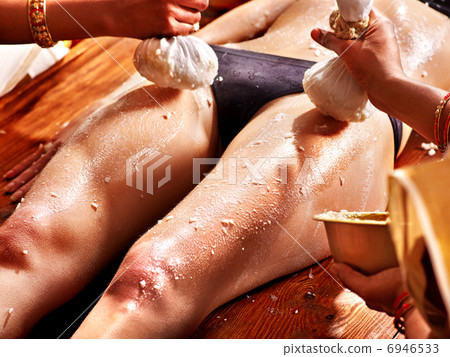 Woman having Ayurvedic feet spa massage. Woman having Ayurvedic feet spa massage. 6946533