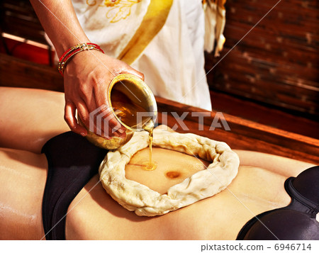 Woman having Ayurvedic spa treatment. Woman having Ayurvedic spa treatment. 6946714