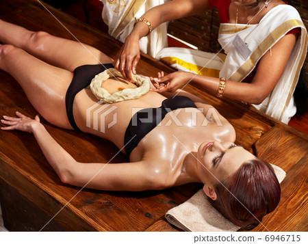 Woman having Ayurvedic spa treatment. Woman having Ayurvedic spa treatment. 6946715