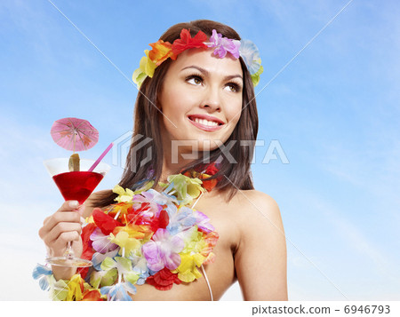 Woman in hawaii costume drink  juice. 6946793