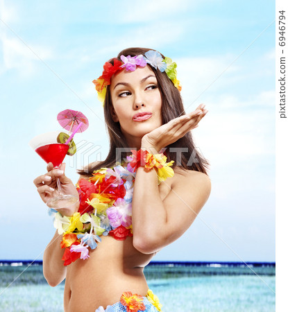 Woman in hawaii costume drink juice. Woman in hawaii costume drink juice. 6946794