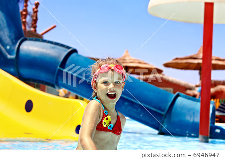 Child on water slide at aquapark. Child on water slide at aquapark. 6946947