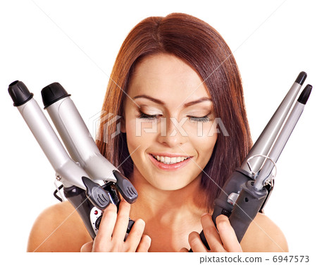 Woman holding iron curling hair. 6947573