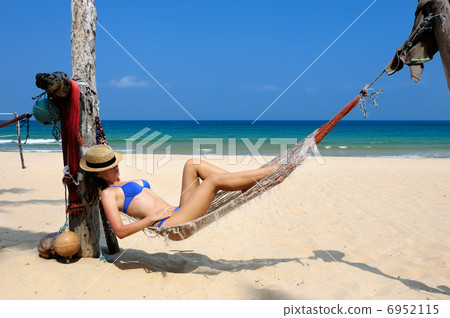 Woman in hammock on beach Woman in hammock on beach 6952115