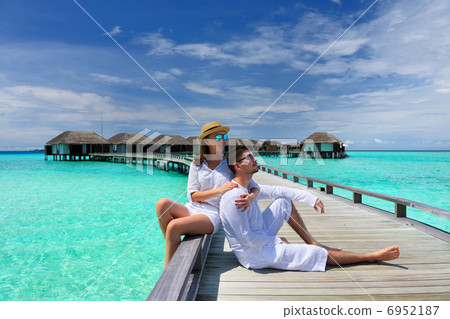 Couple on a beach jetty at Maldives Couple on a beach jetty at Maldives 6952187