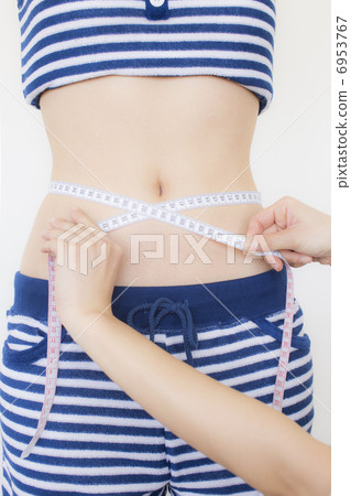 一個女人測量腰圍 6953767
