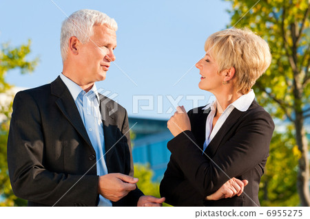 Business people talking outdoors 6955275