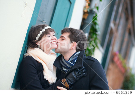 Happy romantic couple kissing outdoors 6961539