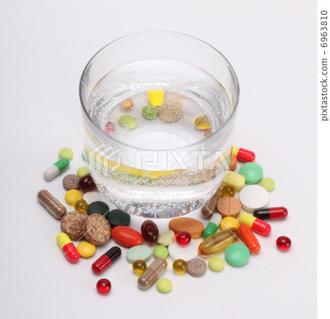 vitamins, tablets and pills and glass of water vitamins, tablets and pills and glass of water 6963810