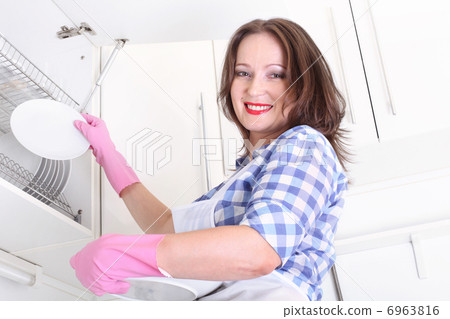 smiling woman in kitchen 6963816