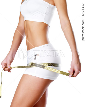 Beautiful feamle body with measuring tape. 6971332