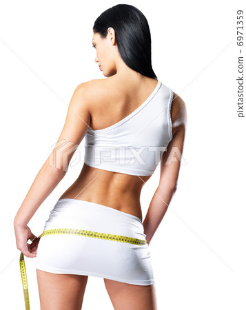 Sporty woman with slim body measuring hips Sporty woman with slim body measuring hips 6971359