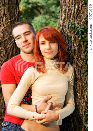 Young attractive couple in a forest Young attractive couple in a forest 6971629