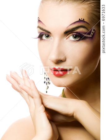 Beautiful young woman with creative make-up on her face 6971633
