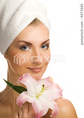 Beautiful young woman with pink lily Beautiful young woman with pink lily 6971680