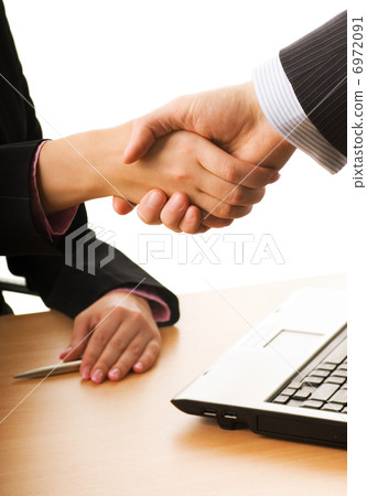 Business man and business woman making a treaty 6972091