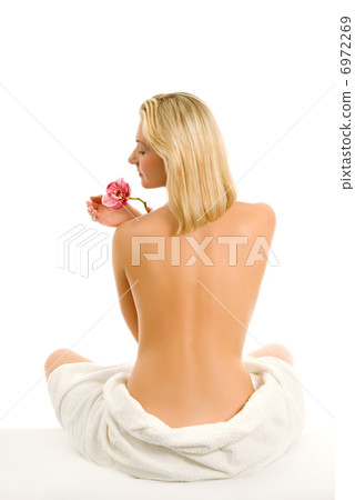 Beautiful young woman with orchid flower isolated on white backg 6972269