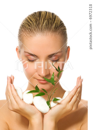 Beautiful blond girl holding young plant growing up through ston Beautiful blond girl holding young plant growing up through ston 6972318