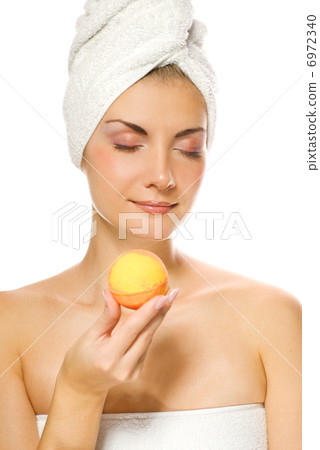 Beautiful young woman with aroma bath ball isolated on white bac Beautiful young woman with aroma bath ball isolated on white bac 6972340